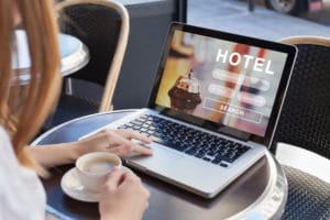 booking hotel on internet, travel planning, online reservation concept, woman looking at screen of computer searching accommodation